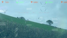 Animation of infographic interface with clock over windmills on grassy hill against sky. Digital composite, multiple exposure, sustainable energy, wind power, database, nature, business, technology. - Powered by Shutterstock - Get 15% off with code: PIKWIZARD15