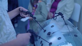 A teenager is learning to become a doctor on a simulator – laparoscopy is a modern method of minimally invasive surgery through small openings - Powered by Shutterstock - Get 15% off with code: PIKWIZARD15