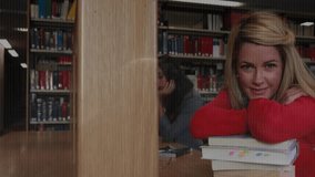 Studying in library, students with binary code animation in background. Technology, education, coding, digital, innovation, programming - Powered by Shutterstock - Get 15% off with code: PIKWIZARD15