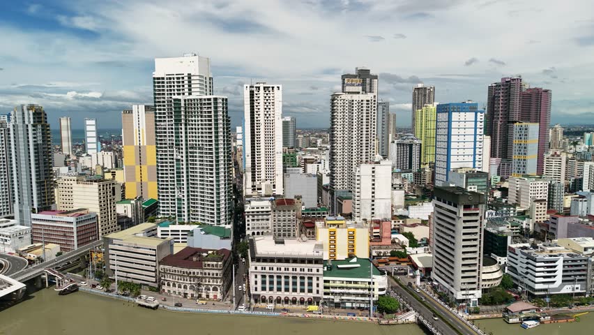 Smooth slow-motion aerial cinematography gliding laterally across Manila