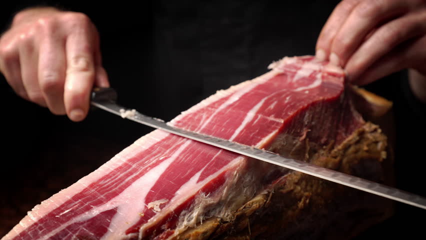 Professional Hands Slicing Iberian Ham from Side Angle, Slow Motion 4K
