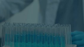 Animation of molecules over caucasian scientist with test tubes in laboratory. global science, research and data processing concept digitally generated video. - Powered by Shutterstock - Get 15% off with code: PIKWIZARD15