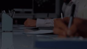 Animation of stock market data processing over mid section of businessman taking notes at office. Global economy and business technology concept - Powered by Shutterstock - Get 15% off with code: PIKWIZARD15