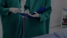 Animation of financial data processing and globe over diverse surgeons. Global medicine, business, finance, computing and data processing concept digitally generated video. - Powered by Shutterstock - Get 15% off with code: PIKWIZARD15