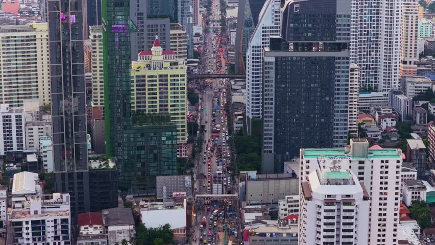 Aerial view of a busy street in Thanon Phaya Thai, Bangkok, Thailand. Modern skyscrapers and buildings surrounding a main road in the city