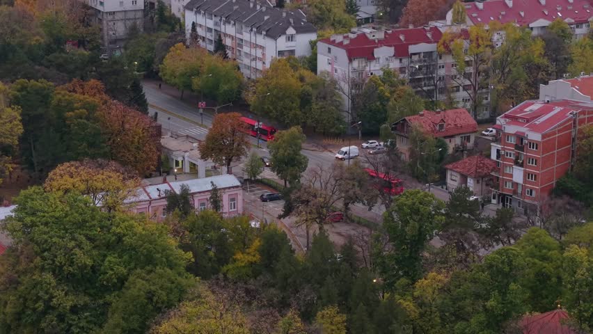 Drone flight over a busy road in Niš, Serbia, revealing the cityscape as traffic flows through the urban landscape.
