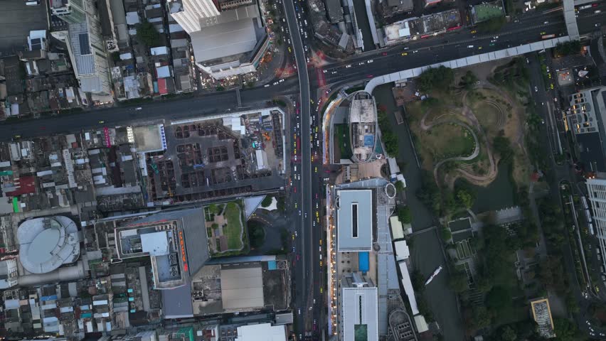 Aerial top down view of Bangkok city skyline, showing modern buildings, skyscrapers, busy roads, heavy traffic, and urban development