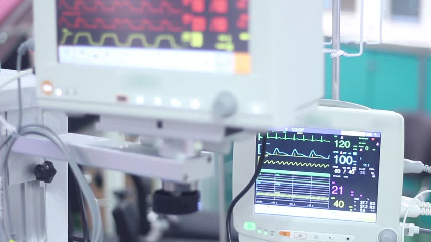 Close-up of heart monitors in a hospital, displaying vital signs and patient data, illustrating healthcare, medical technology, and patient care.