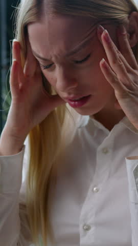 Tired ill sick fatigued Caucasian businesswoman holding head pain headache working laptop business woman irritated with computer problem error failure female girl work hard feeling stress in office