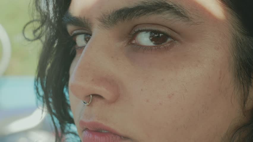 Extreme close-up of a woman’s face as she slowly opens and closes her eyes.