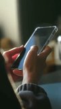 Hands tap phone, Closeup of hands engaging with smartphone, Focus on fingers touching phone under gentle interior lighting, Detailed view of hands swiftly navigating smartphone in modern setting - Powered by Shutterstock - Get 15% off with code: PIKWIZARD15