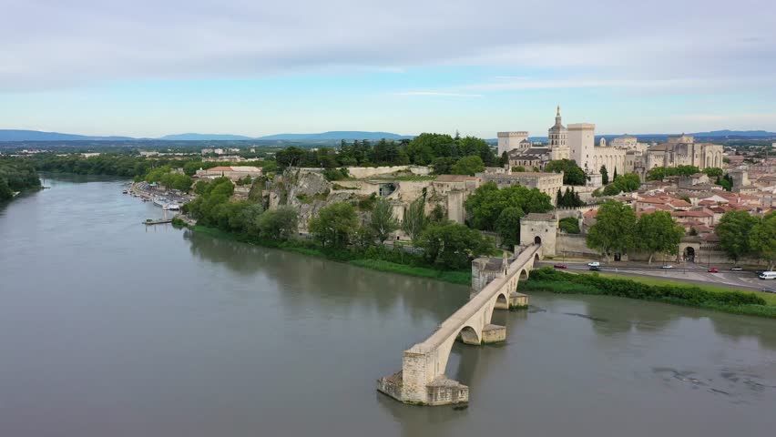 Beautiful view of Avignon with famous bridge Saint-Benezet, medieval architecture along the Rhone River in Avignon, France. The Pont Saint Benezet and the Papal palace in Avignon, South France.