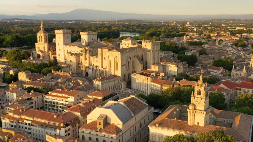 View of Avignon with Palais des Papes during sunset in Southern France. Medieval architecture along the Rhone River in Avignon, Provence, France. The Palais des Papes in Avignon, South France.