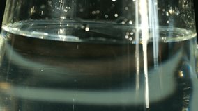 Clear glass with dynamic bubbles, Streaming air creates turbulent movements in vibrant beverage, Mixologist observes lively carbonation swirling within transparent glass as air flows vividly - Powered by Shutterstock - Get 15% off with code: PIKWIZARD15