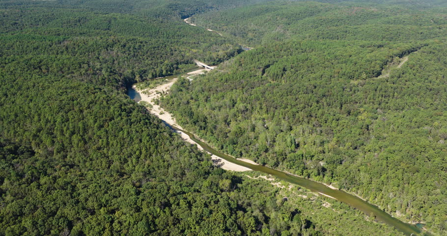North Fork River Through Forested Hills With Dense Green Woodland In Ozark County, Missouri. aerial shot