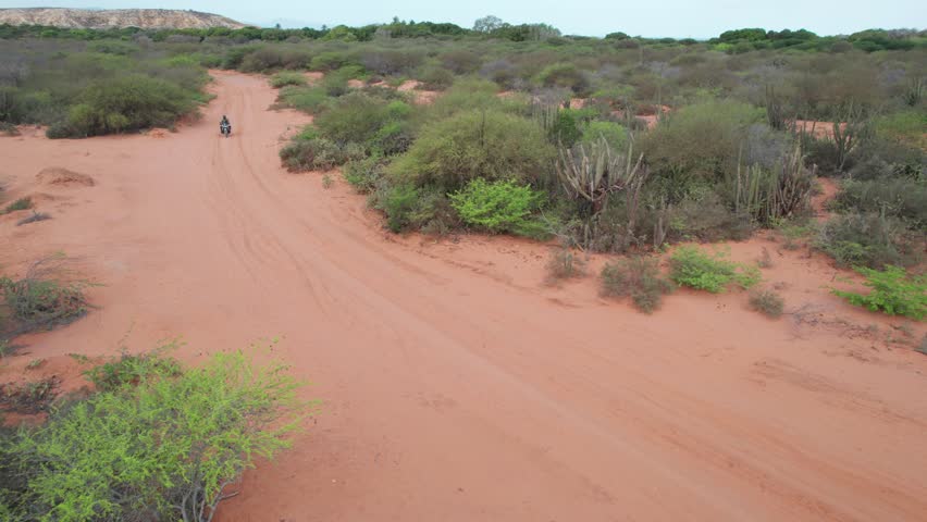 Aerial Drone View of Motorcyclist Crossing Desert in Araya Venezuela