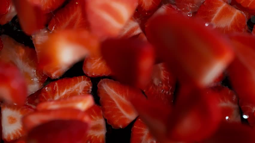 Super Slow Motion Shot of Fresh Strawberries Falling into Water at 1000fps.