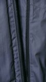 Closeup person fastening coat, Authentic candid moment of woman sealing her jacket zipper outdoor, Detailed shot of female securing jacket zipper with textured fabric. Vertical. - Powered by Shutterstock - Get 15% off with code: PIKWIZARD15