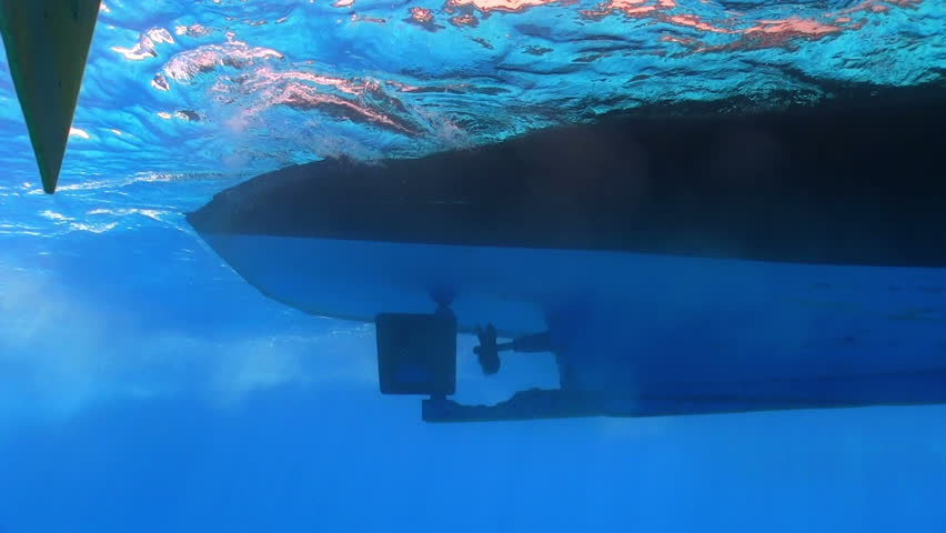 View of the propeller from the bottom of the ship under water