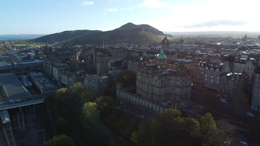 Panning across the skyline drone shot Edinburgh Arthur