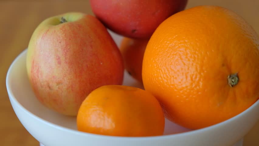 Beautiful fruits on a plate cut and whole