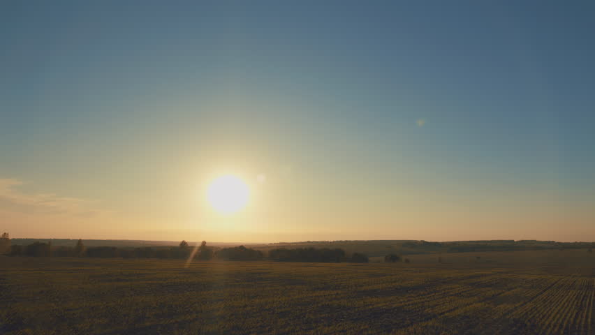 A Serene Sunrise Offers Its Beauty Over the Agricultural Landscape, Captivating All Who See It