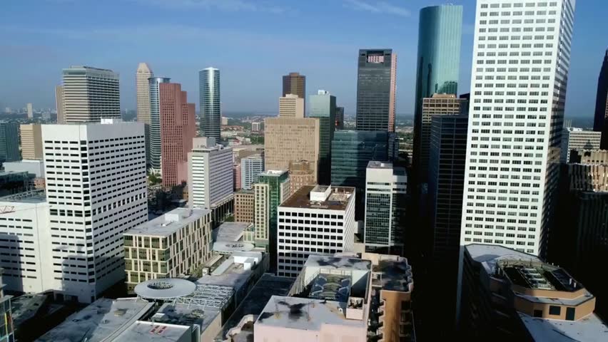 Panoramic view of the Houston skyline in Texas, USA, featuring modern skyscrapers, urban architecture, and a vibrant cityscape under a clear sky.
