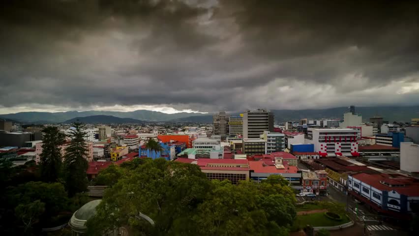 Overcast sky looms above the cityscape of San José, Costa Rica, highlighting urban architecture, atmospheric weather, and metropolitan environment.