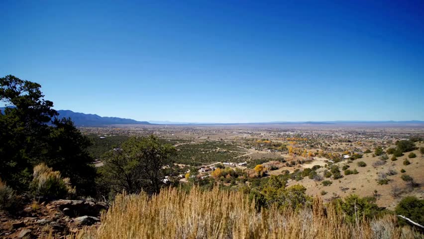Scenic view of Albuquerque, New Mexico from the mountains, showcasing urban skyline, surrounding landscape, and Southwestern natural beauty.
