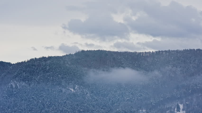 Snowy Mountain Ridge with Low Clouds Winter Landscape Romania