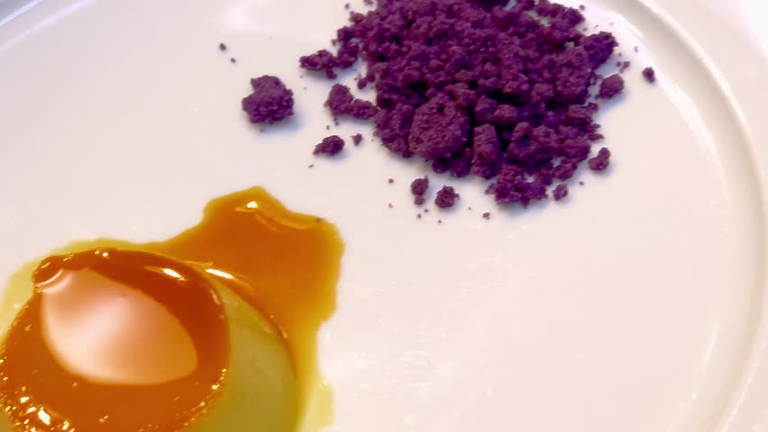 Close-up video of cream brulee with crispy caramel top.