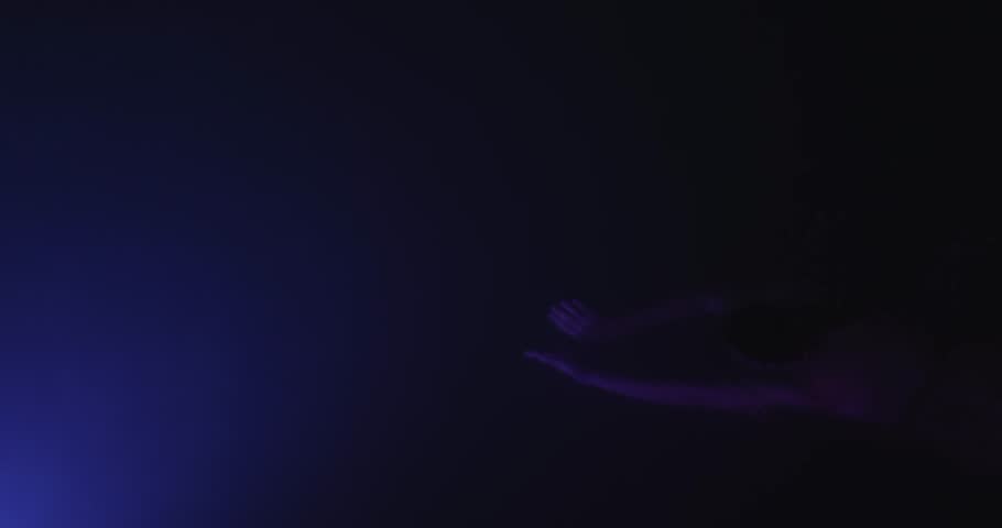 Sensual female model swims underwater in deep blue lighting, creating a dreamy, artistic atmosphere. High quality conceptual video perfect for beauty, fashion, or luxury promo content. 