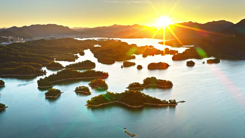 Aerial view of the beautiful lake and green islands with mountain natural landscape at sunrise. Famous Qiandao Lake scenery in Hangzhou, China. 