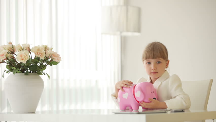 Little businesswoman with piggy bank
