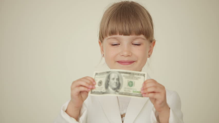 Little girl holding banknote
