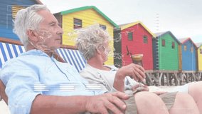 Animation of financial data processing with world map over senior caucasian couple at beach. Global lifestyle, finances and digital interface concept digitally generated video. - Powered by Shutterstock - Get 15% off with code: PIKWIZARD15