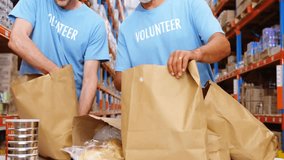 Animation of network of connections with icons over caucasian male volunteers in warehouse. Global business and digital interface concept, digitally generated video. - Powered by Shutterstock - Get 15% off with code: PIKWIZARD15