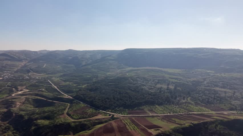 Wide aerial view of the mountainous landscape of the Golan Heights near Lake Kinneret, Israel.