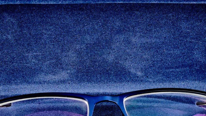 Blue spectacles rest in a luxurious case, the word Revision subtly etched inside. The image transitions, highlighting clarity and the evolution of vision.