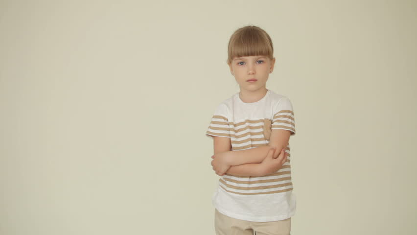 Little girl standing with her hands folded
