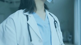 Animation of virus cells over asian female doctor with face mask. Global pandemic, patriotism and digital interface concept digitally generated video. - Powered by Shutterstock - Get 15% off with code: PIKWIZARD15