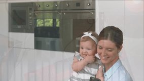 A woman is holding her daughter and using a phone at home. Financial data and graphs are displayed over a globe, with connections between them. This video represents global finance, economy, business - Powered by Shutterstock - Get 15% off with code: PIKWIZARD15
