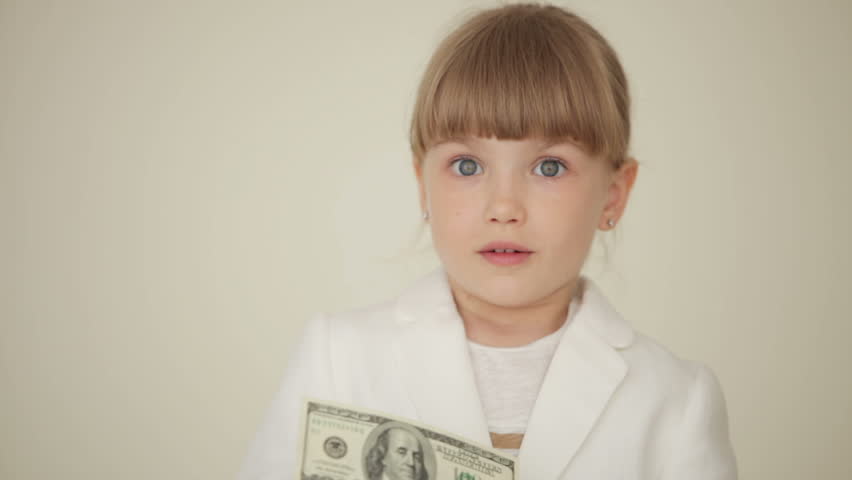 Little girl holding a money bill and shows ok
