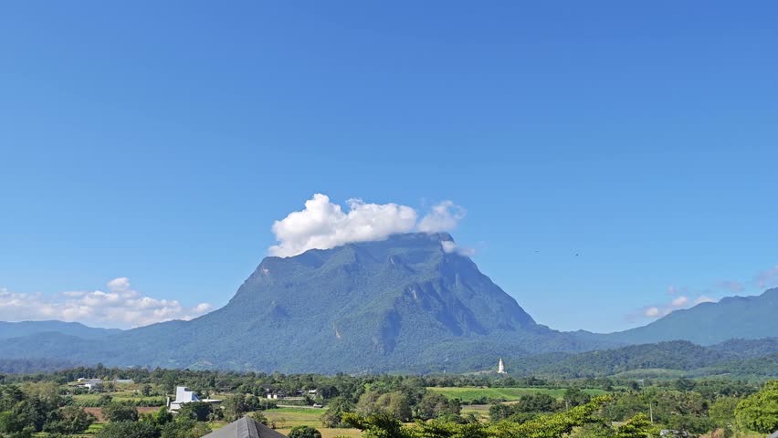 Scenic mountain view with dramatic sunlight and clouds.