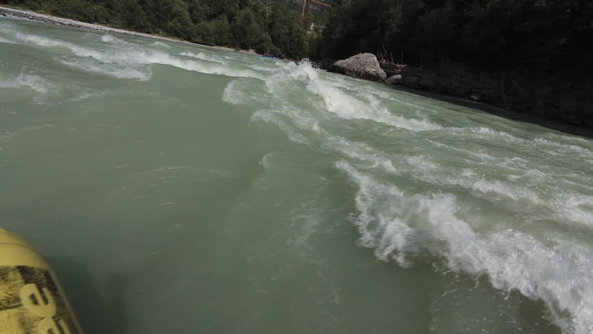 First point of view tourist floats on a raft on the river, rafting. Active recreation in the Alpine mountains.