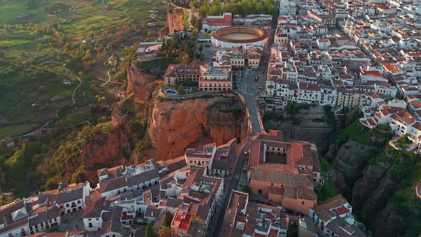 Ronda, Spain. Aerial view of the New Bridge over Guadalevin River in Ronda medieval town at sunset, Andalusia, Spain. Famous UNESCO heritage city and Puente Nuevo bridge at sunset