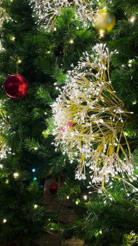 A close-up of a Christmas tree decorated with cute Christmas ornaments. Welcoming Christmas and New Year celebrations.