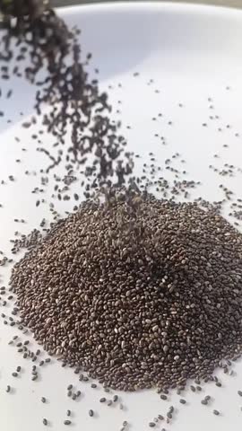 Healthy and Nutritious chia seed falling on white plate 