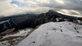 Side Track Shot of a Snowy Rocky Lookout with a View of Winter Panorama and Mountain Peak. - Powered by Shutterstock - Get 15% off with code: PIKWIZARD15