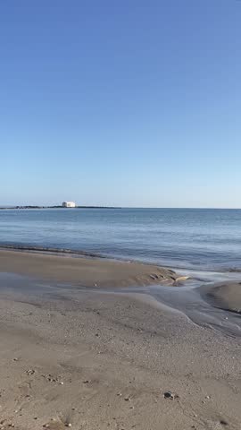 Vertical view of Agios Nikolaos Church in Georgioupoli, white chapel in the sea, calm water and sunny weather, Crete